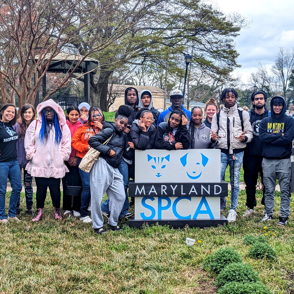 Group of volunteers around Maryland SPCA sign