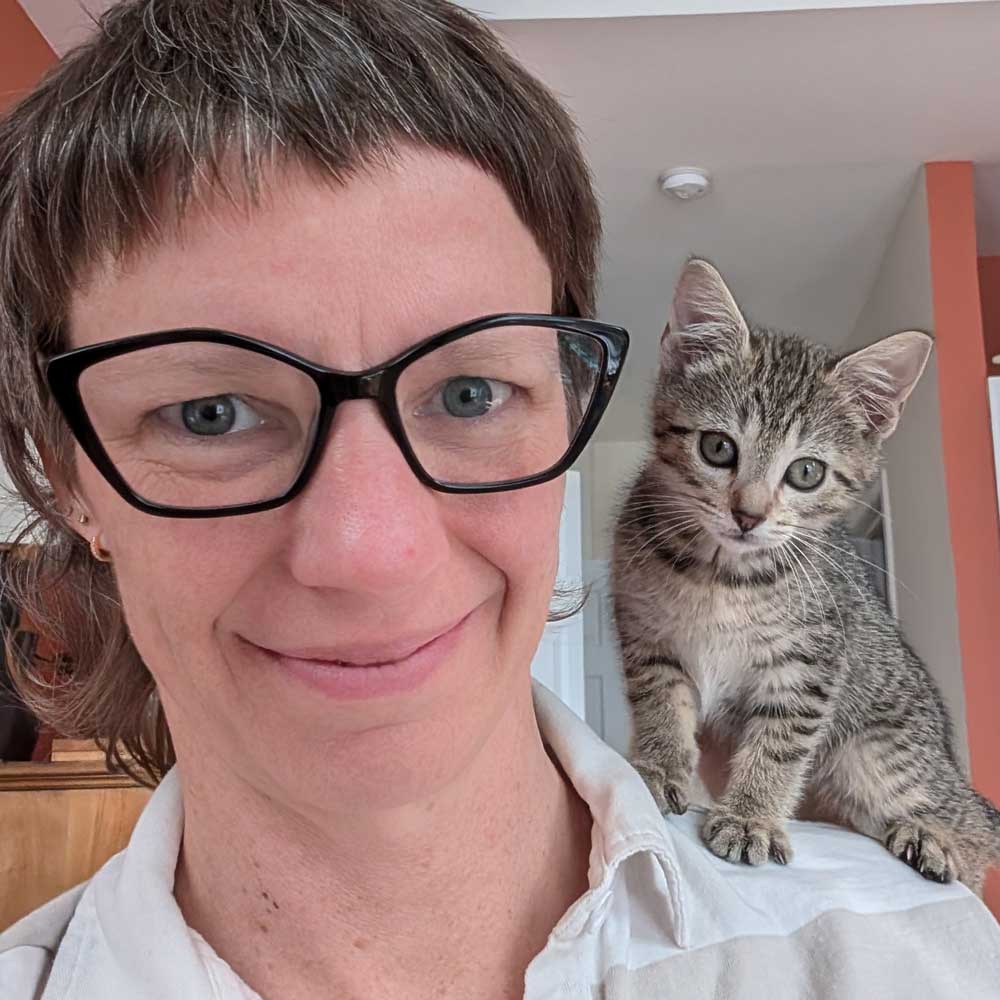 Foster parent with kitten on shoulder