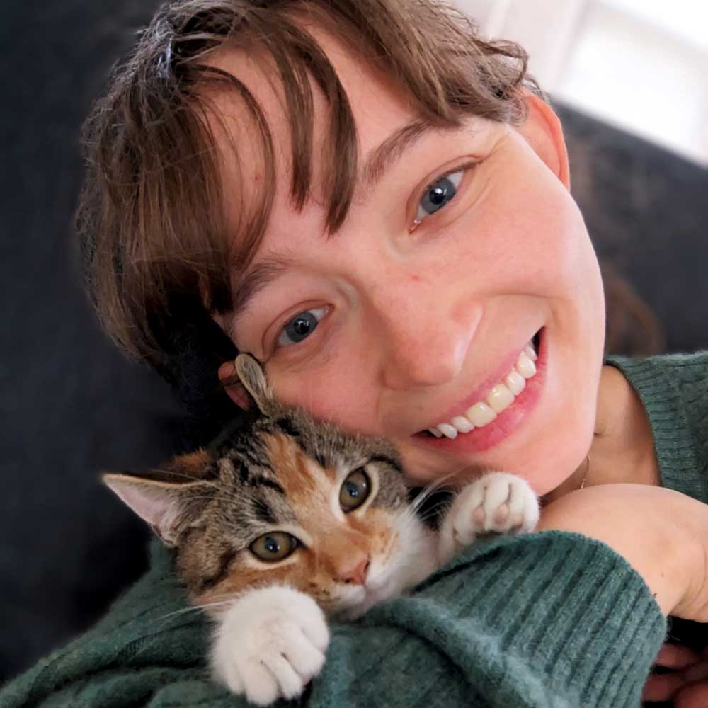 Foster parent snuggling with cat