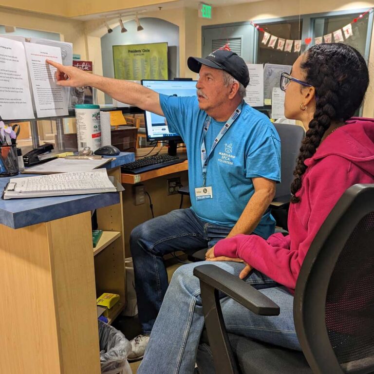 Volunteer training another volunteer on front desk duties