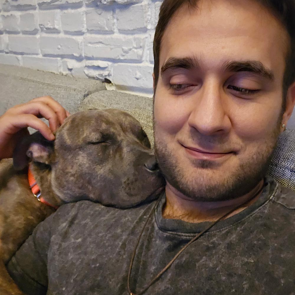 Foster parent snuggling with foster dog