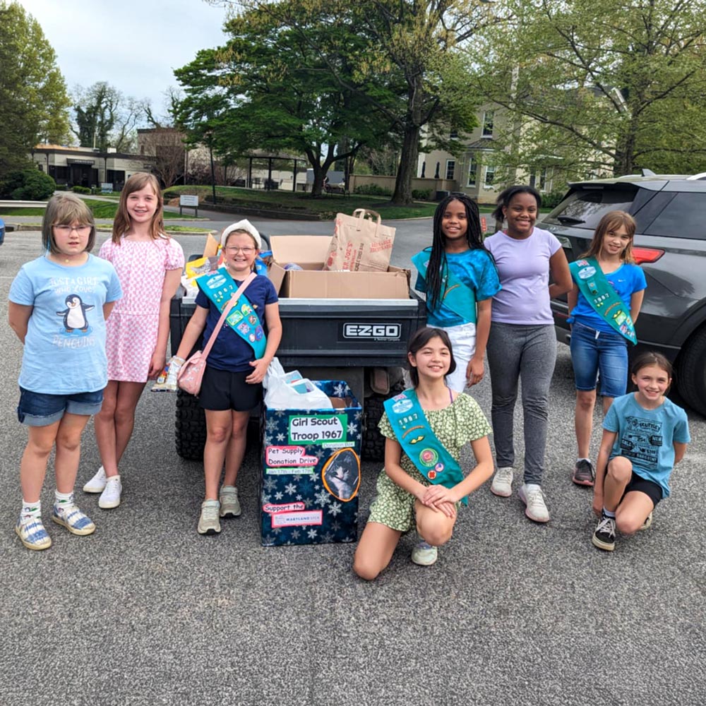 Group of girl scouts with donations