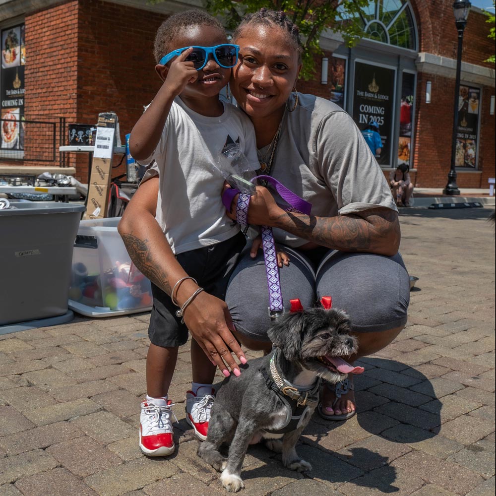 Mother and child with small dog at a Maryland SPCA event